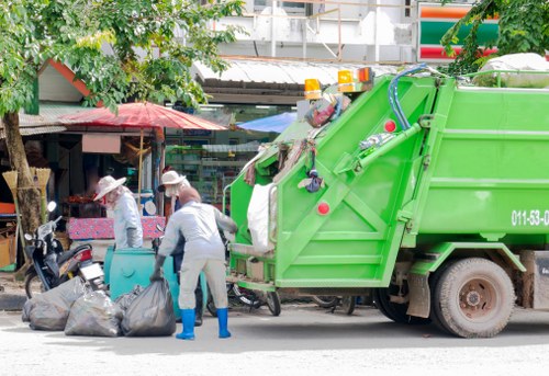 Operatives loading rubbish into a secure skip during a business clearance