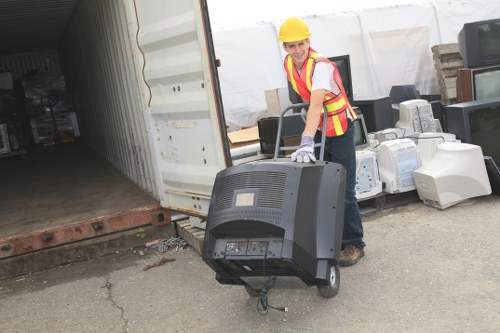 Staff sorting mixed recyclables into separate containers